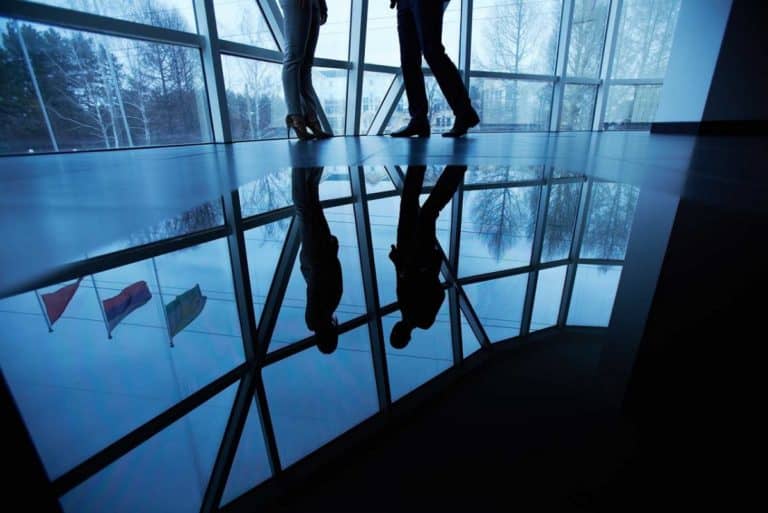floor shot of business people talking in office hallway