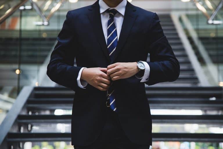business man walking own stairs in modern office building