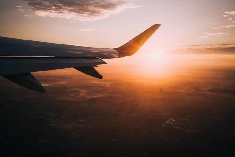 view looking out over plane wing during sunset