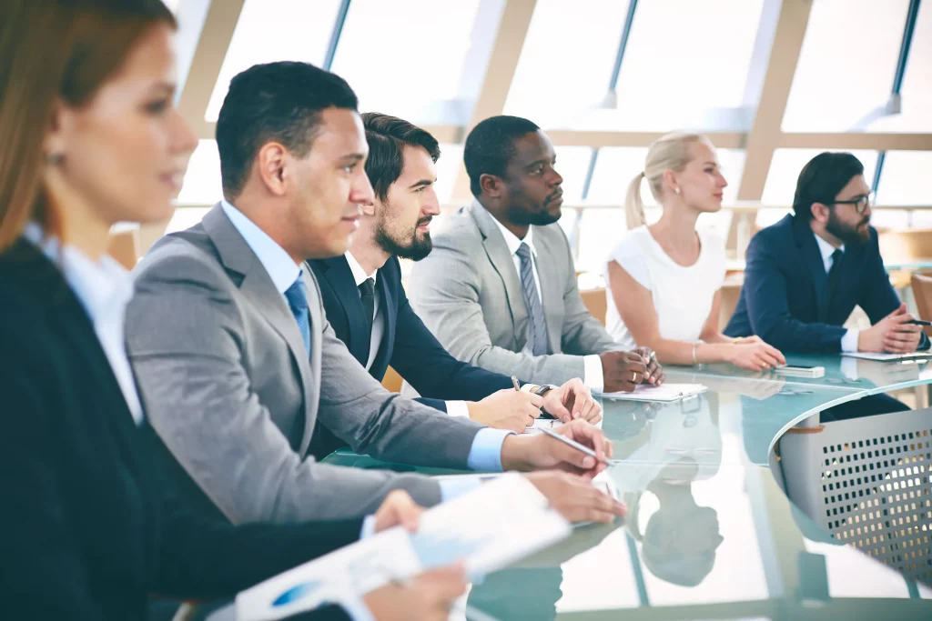 large group of business students sitting at a desk in a lesson