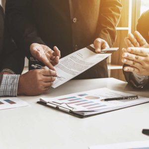 A group of business people discussing bankruptcy and debt agreements.