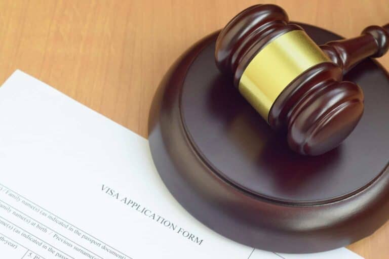 A wooden gavel sits on top of a legal document, depicting the seriousness and authority associated with visa applications or training under subclass 407.